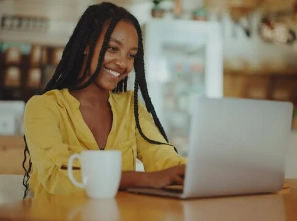 smiling woman using a laptop