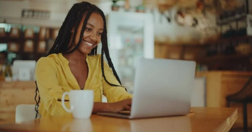 smiling woman using a laptop